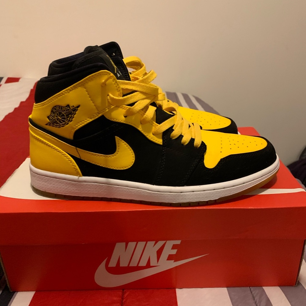 Yellow and black Mid top Jordan One’s